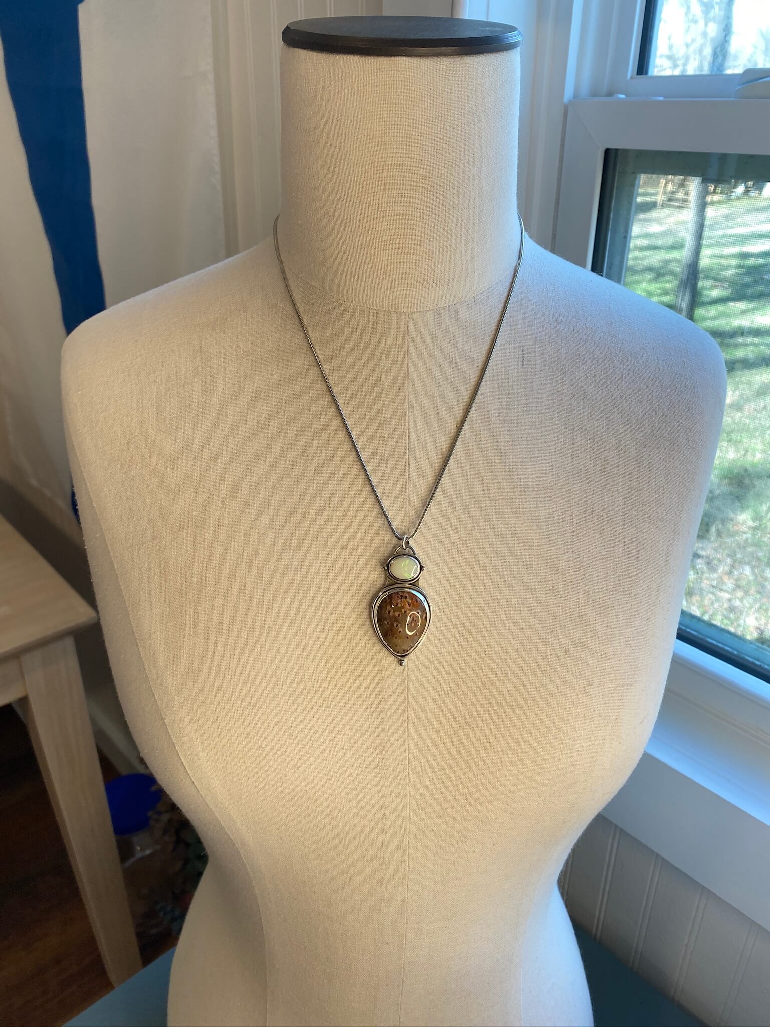 Petrified Palm Wood and Opal sterling silver pendant - draped view