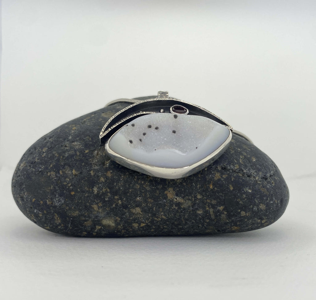 White druzy quartz with black spots and garnet_front angled view