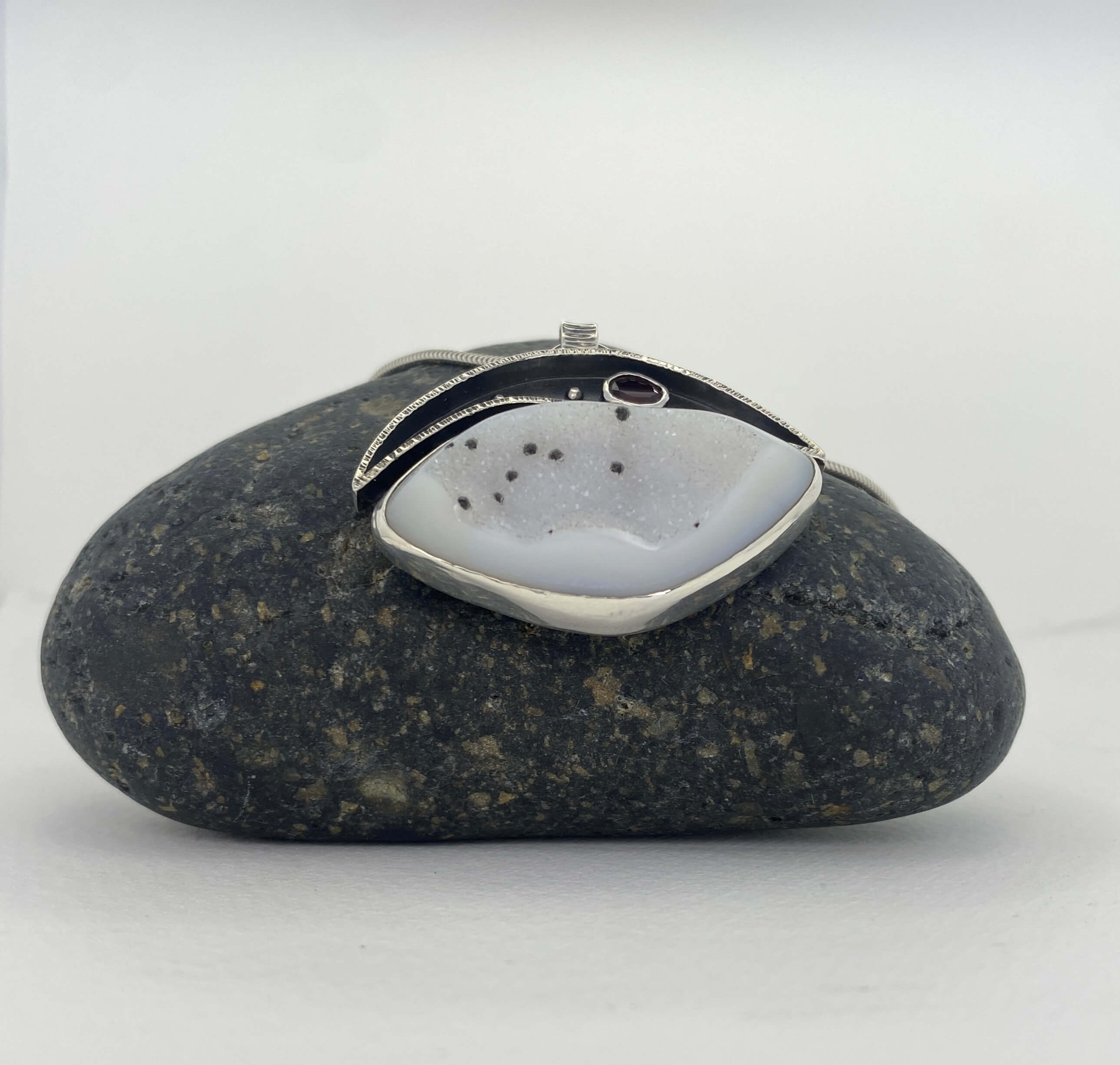 White druzy quartz with black spots and garnet_front angled view
